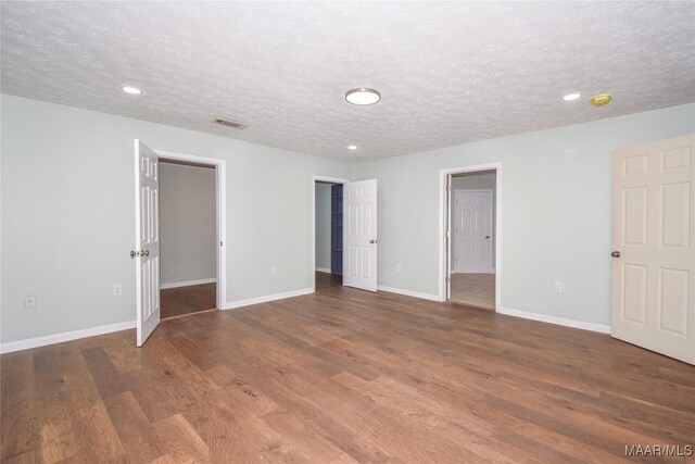 6790 Upper River Rd, Tallassee, AL 36078 - empty room with wood finished floors, a textured ceiling, recessed lighting, and baseboards