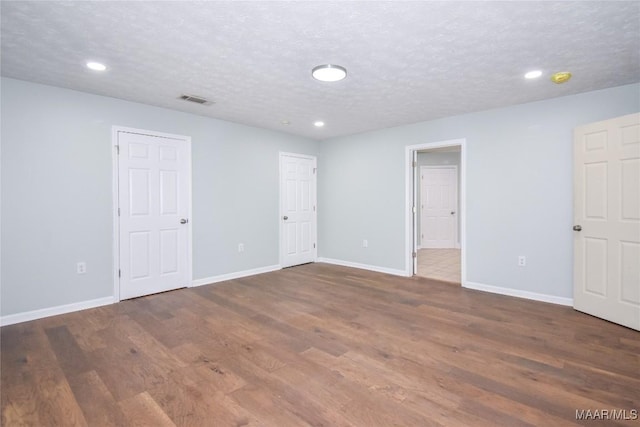 6790 Upper River Rd, Tallassee, AL 36078 - unfurnished bedroom featuring wood finished floors, baseboards, recessed lighting, and a textured ceiling