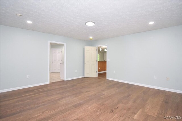 6790 Upper River Rd, Tallassee, AL 36078 - empty room with wood finished floors, baseboards, a textured ceiling, and recessed lighting