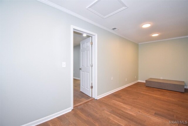 6790 Upper River Rd, Tallassee, AL 36078 - unfurnished room featuring wood finished floors, ornamental molding, baseboards, and attic access