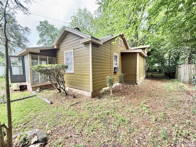 2121 Lauderdale St, Selma, AL 36701 - view of side of property with a sunroom, cooling unit, and fence
