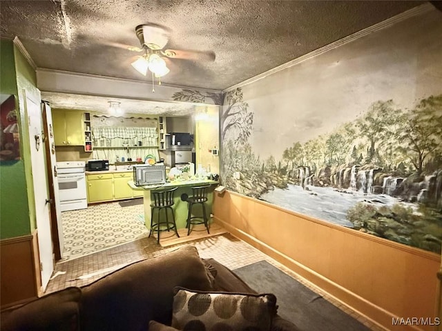 2121 Lauderdale St, Selma, AL 36701 - dining space featuring crown molding, a ceiling fan, a textured ceiling, and a wainscoted wall