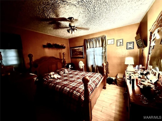 2121 Lauderdale St, Selma, AL 36701 - bedroom featuring a textured ceiling, a ceiling fan, and wood finished floors