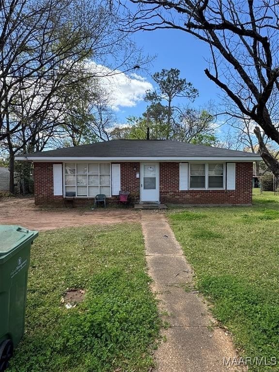 single story home with brick siding and a front lawn