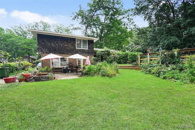 back of property with brick siding, a patio area, and mansard roof
