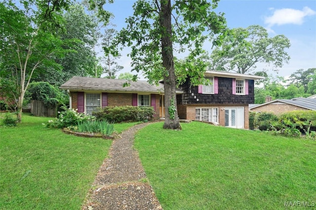 split level home with brick siding and a front yard