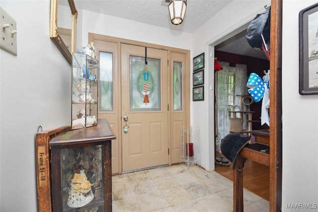 entrance foyer featuring a textured ceiling