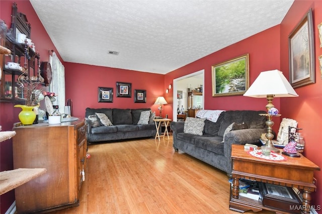 living room with wood finished floors and a textured ceiling