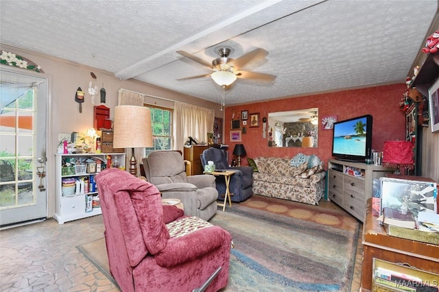 living area with plenty of natural light, a ceiling fan, and a textured ceiling