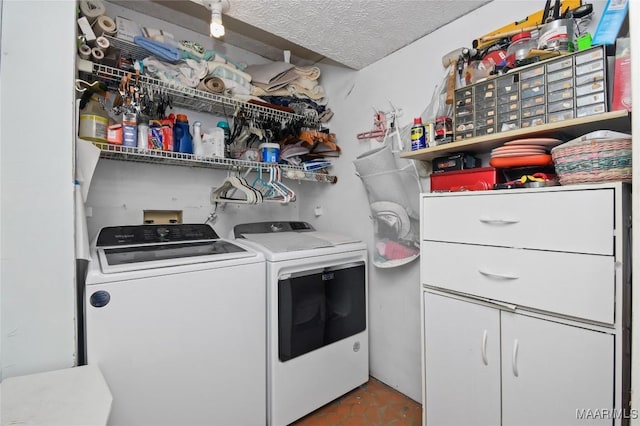 washroom featuring washer and dryer and a textured ceiling