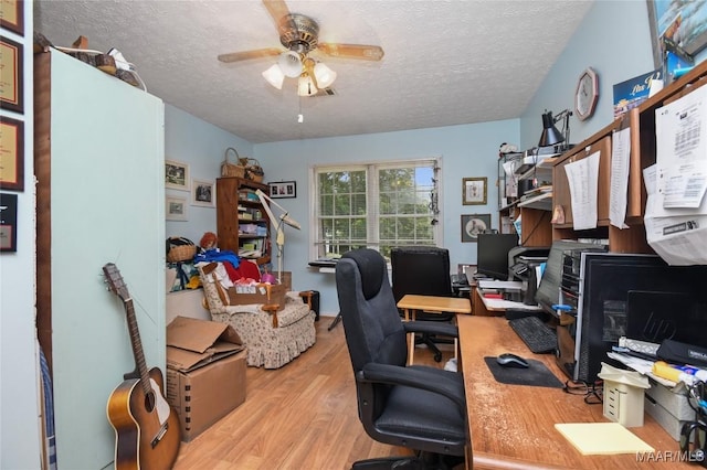 office space with a textured ceiling, wood finished floors, and a ceiling fan