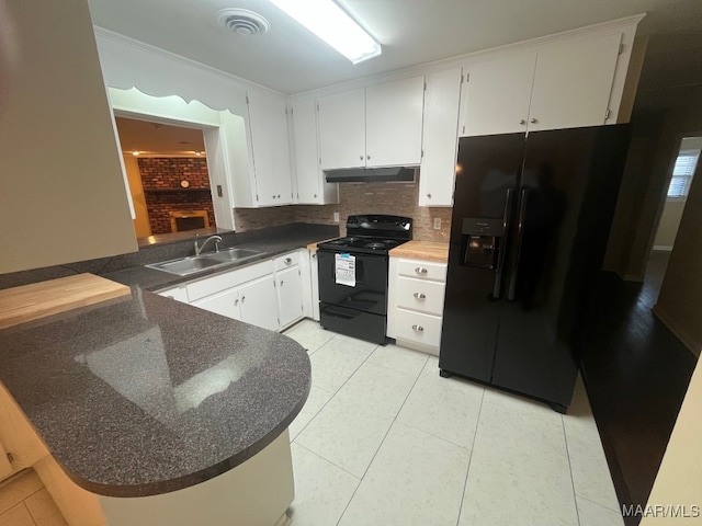 kitchen with black appliances, a sink, under cabinet range hood, a peninsula, and light tile patterned floors