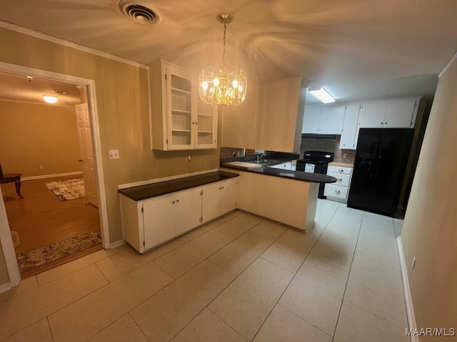 kitchen with black refrigerator with ice dispenser, a peninsula, a chandelier, decorative backsplash, and glass insert cabinets