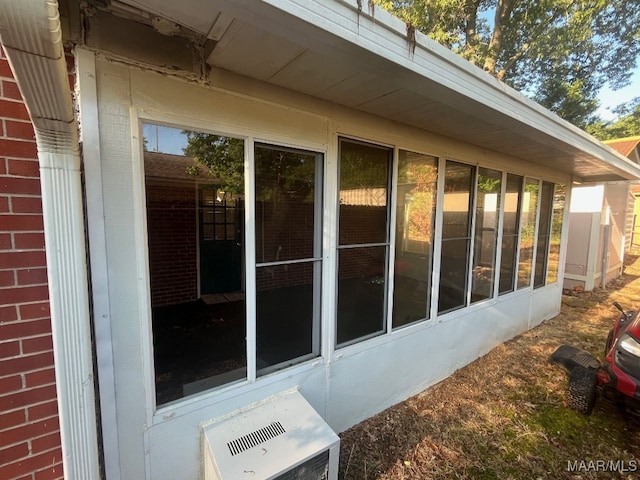view of property exterior with a sunroom