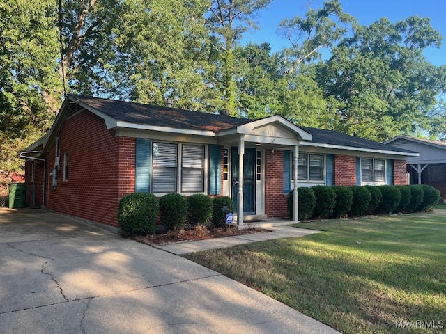 single story home with brick siding, a front yard, and concrete driveway