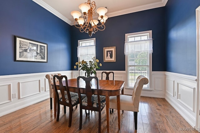 65 Copper Ridge Ct, Deatsville, AL 36022 - dining space with a chandelier, crown molding, a wainscoted wall, and wood-type flooring