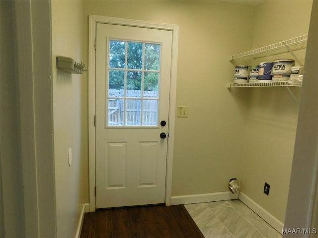 clothes washing area featuring baseboards