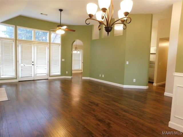 unfurnished living room featuring a chandelier, wood-type flooring, a ceiling fan, vaulted ceiling, and baseboards