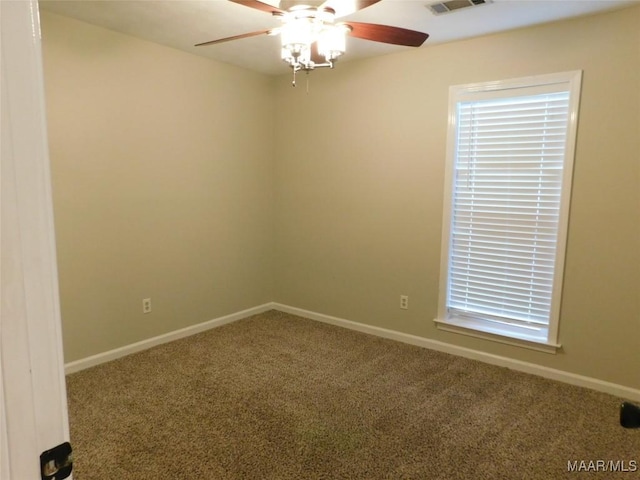 carpeted empty room with baseboards and ceiling fan
