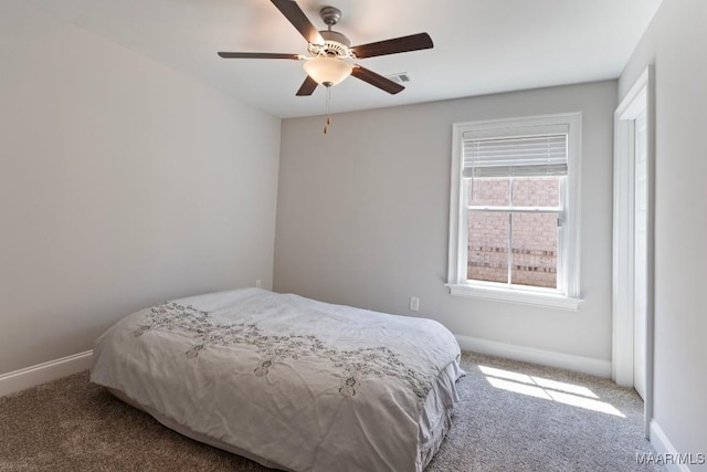 carpeted bedroom featuring baseboards and ceiling fan