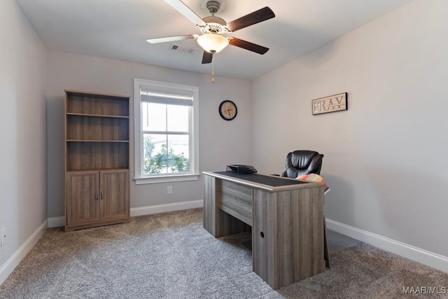 office area with a ceiling fan, carpet, and baseboards