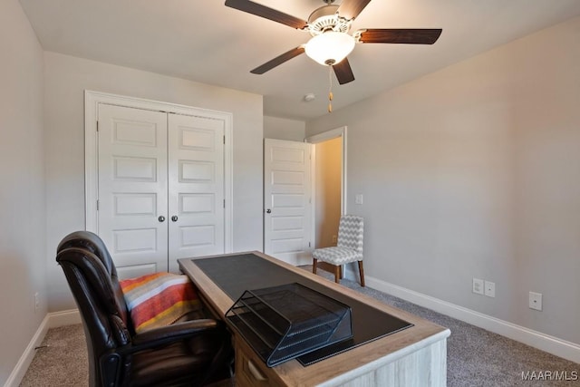 carpeted office with baseboards and ceiling fan