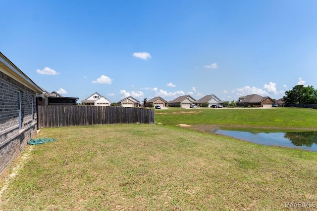 view of yard with a water view and a residential view