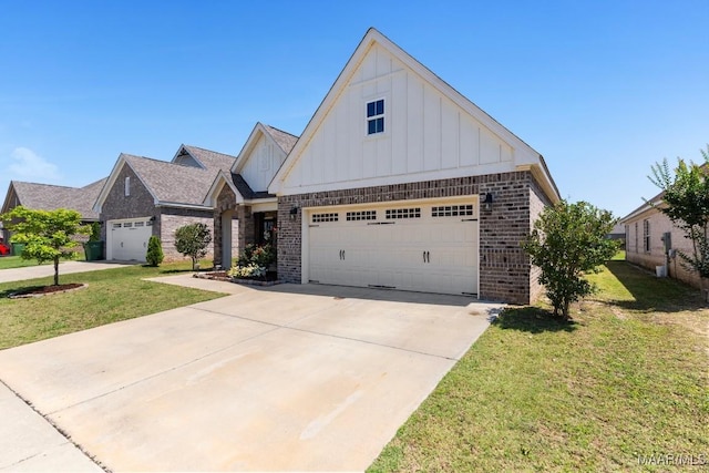 view of front of house featuring board and batten siding, brick siding, a front yard, driveway, and a garage