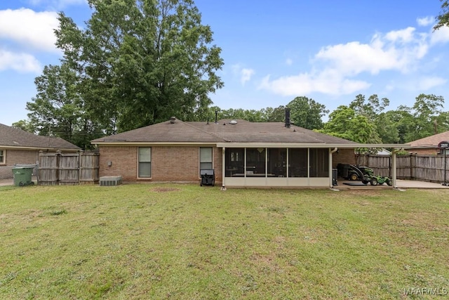 back of house featuring a sunroom, central AC unit, a patio, and brick siding