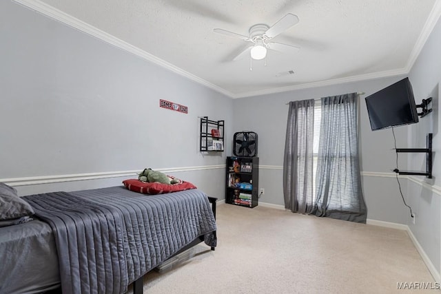 bedroom with ornamental molding, carpet flooring, a textured ceiling, a ceiling fan, and baseboards