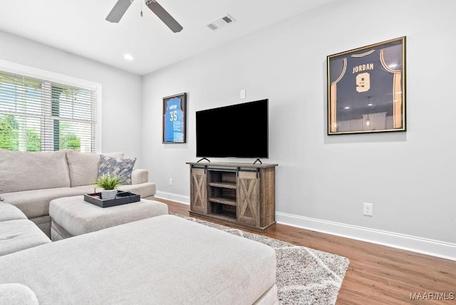 living area with baseboards, wood finished floors, a ceiling fan, and recessed lighting