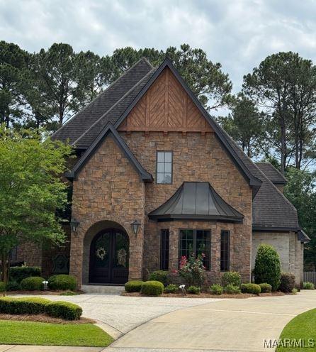 view of front of property featuring stone siding and french doors