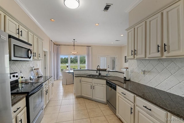 231 Chesson Ct, Fitzpatrick, AL 36029 - kitchen with appliances with stainless steel finishes, a sink, a chandelier, a peninsula, and light tile patterned floors