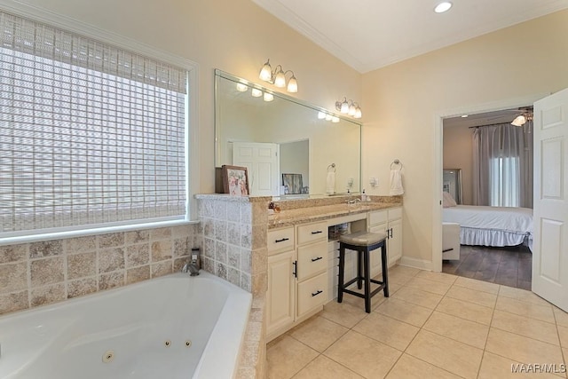 231 Chesson Ct, Fitzpatrick, AL 36029 - ensuite bathroom with tile patterned flooring, a jetted tub, vanity, ornamental molding, and baseboards