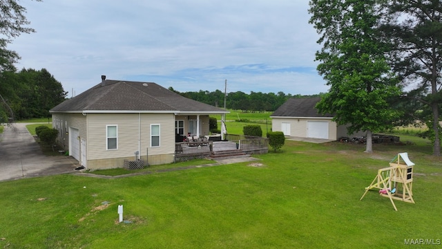 231 Chesson Ct, Fitzpatrick, AL 36029 - rear view of house with a lawn, a detached garage, and an outbuilding