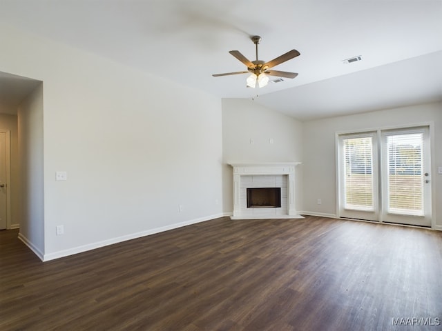 2045 Dawsons Mill Ln, Prattville, AL 36067 - unfurnished living room featuring vaulted ceiling, dark wood-style flooring, ceiling fan, a tiled fireplace, and baseboards