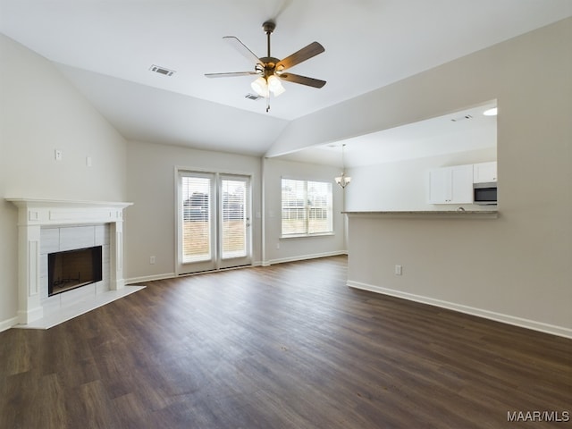 2045 Dawsons Mill Ln, Prattville, AL 36067 - unfurnished living room featuring ceiling fan, a tile fireplace, vaulted ceiling, dark wood finished floors, and baseboards