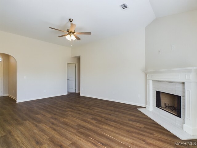 2045 Dawsons Mill Ln, Prattville, AL 36067 - unfurnished living room with a ceiling fan, dark wood finished floors, arched walkways, a fireplace, and baseboards
