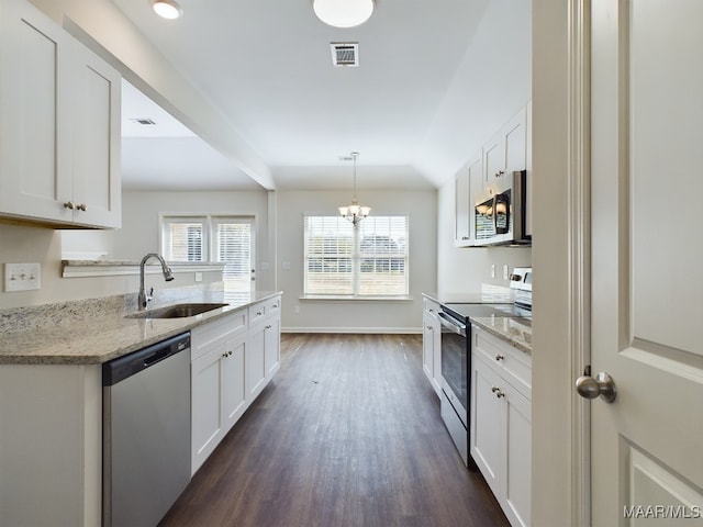 2045 Dawsons Mill Ln, Prattville, AL 36067 - kitchen with stainless steel appliances, a sink, dark wood finished floors, a chandelier, and white cabinetry