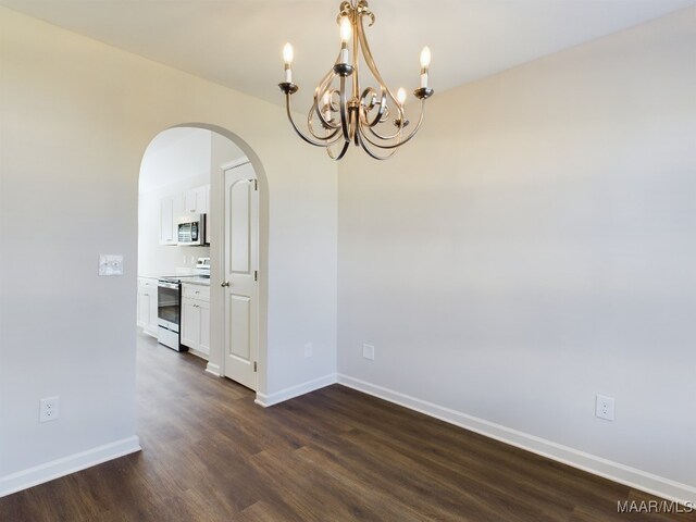 2045 Dawsons Mill Ln, Prattville, AL 36067 - empty room featuring arched walkways, dark wood-style flooring, a chandelier, and baseboards