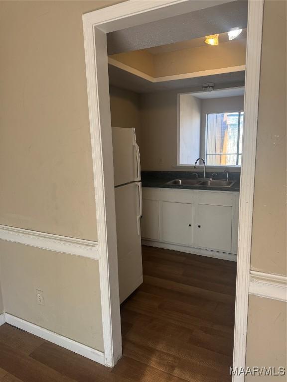 5915 Singleton St, Montgomery, AL 36116 - kitchen featuring freestanding refrigerator, a sink, dark wood-style flooring, and dark countertops