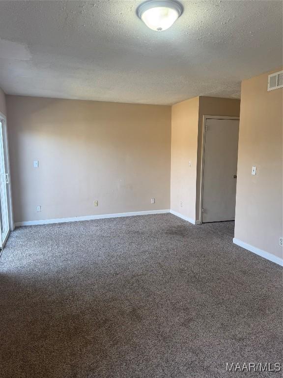 5915 Singleton St, Montgomery, AL 36116 - unfurnished room featuring baseboards, carpet, and a textured ceiling
