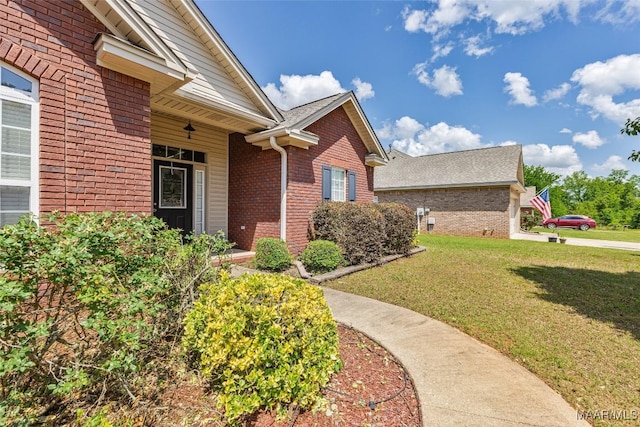 705 Coleman Way, Prattville, AL 36067 - view of exterior entry featuring brick siding, a lawn, and a shingled roof