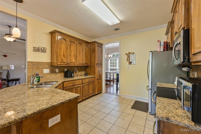 705 Coleman Way, Prattville, AL 36067 - kitchen featuring stainless steel microwave, brown cabinetry, a sink, light tile patterned floors, and a peninsula