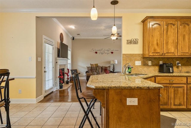 705 Coleman Way, Prattville, AL 36067 - kitchen featuring a sink, light tile patterned flooring, a peninsula, crown molding, and ceiling fan