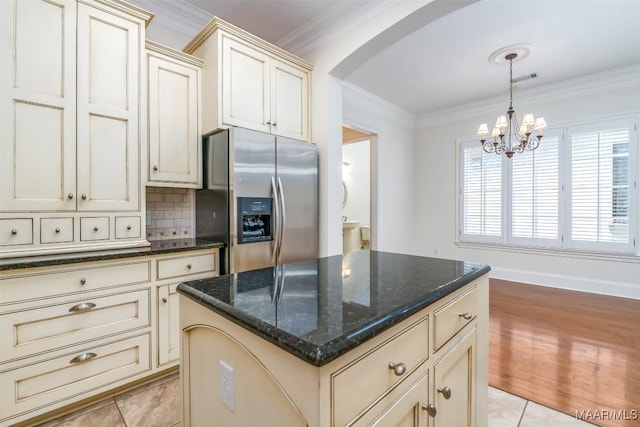 3412 Oak Grove Cir, Montgomery, AL 36116 - kitchen featuring stainless steel refrigerator with ice dispenser, cream cabinets, arched walkways, and ornamental molding