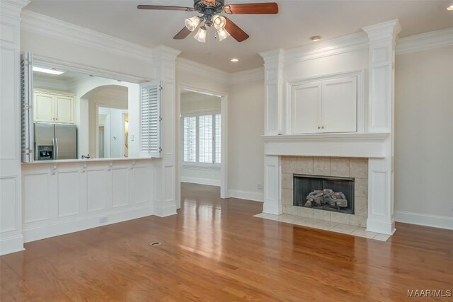 3412 Oak Grove Cir, Montgomery, AL 36116 - unfurnished living room with a ceiling fan, wood finished floors, baseboards, crown molding, and a fireplace