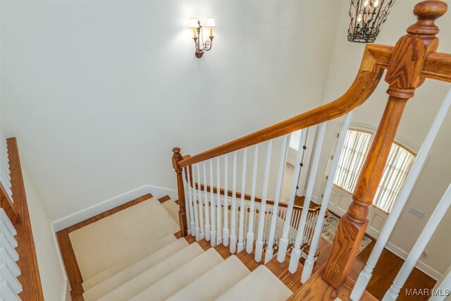 3412 Oak Grove Cir, Montgomery, AL 36116 - stairway featuring a chandelier, wood finished floors, and baseboards