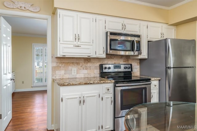 3469 Warrenton Rd, Montgomery, AL 36111 - kitchen featuring stainless steel appliances, ornamental molding, decorative backsplash, white cabinetry, and dark wood finished floors