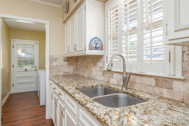 3469 Warrenton Rd, Montgomery, AL 36111 - kitchen featuring a sink, white cabinets, dark wood-style floors, backsplash, and ornamental molding